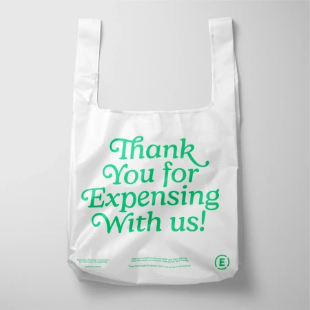 White reusable shopping bag with green text "Thank You for Expensing With Us!" against a white background, eco-friendly shopping.