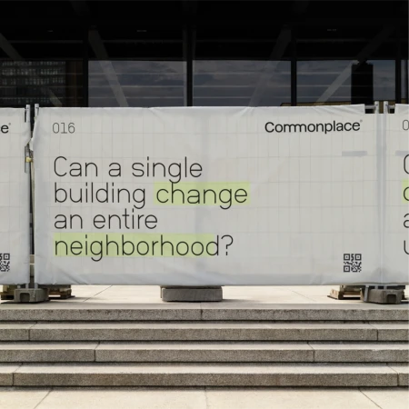 Building under construction, construction banner featuring the text 'Can a single building change an entire neighborhood?' on site.