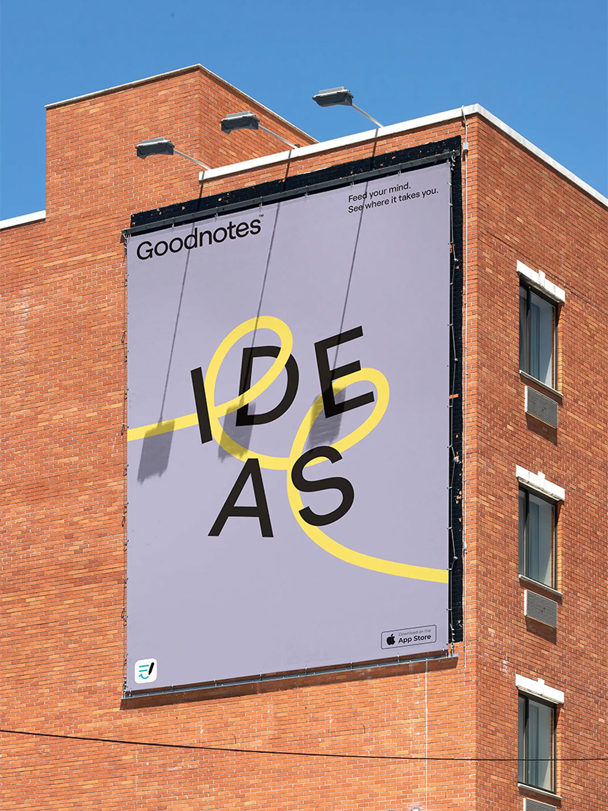 Outdoor billboard advertisement for Goodnotes featuring the word IDEAS in black lettering connected by a yellow line against a building.