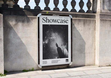 An outdoor advertising poster for UWE showcase mounted on a stone wall beneath a classic balustrade