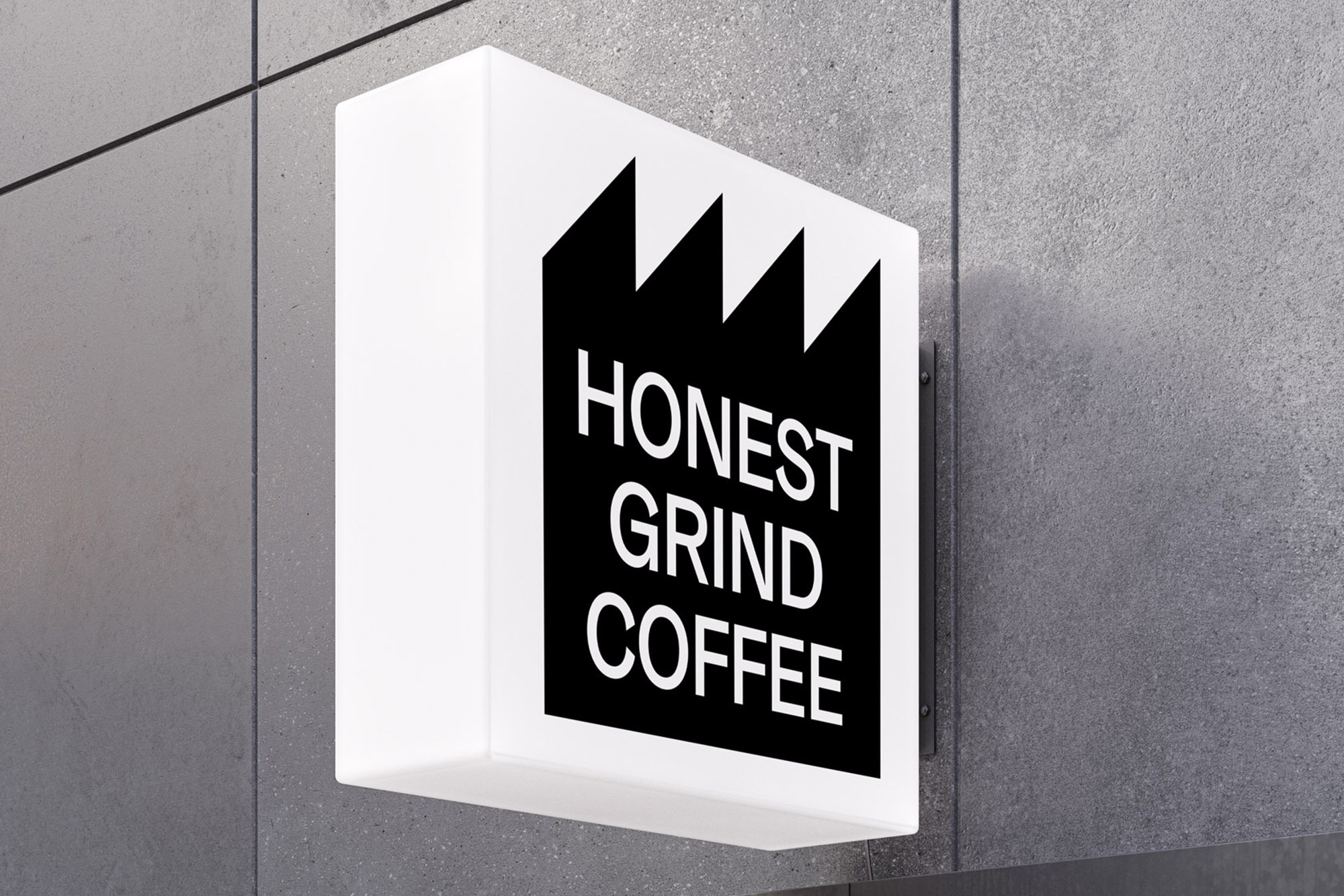 Illuminated white sign mounted on a gray stone wall featuring the black logo and text 'Honest Grind Coffee' in a close-up shot.