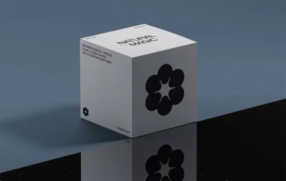 White branded cube box with a black floral logo and typography resting on a dark reflective surface