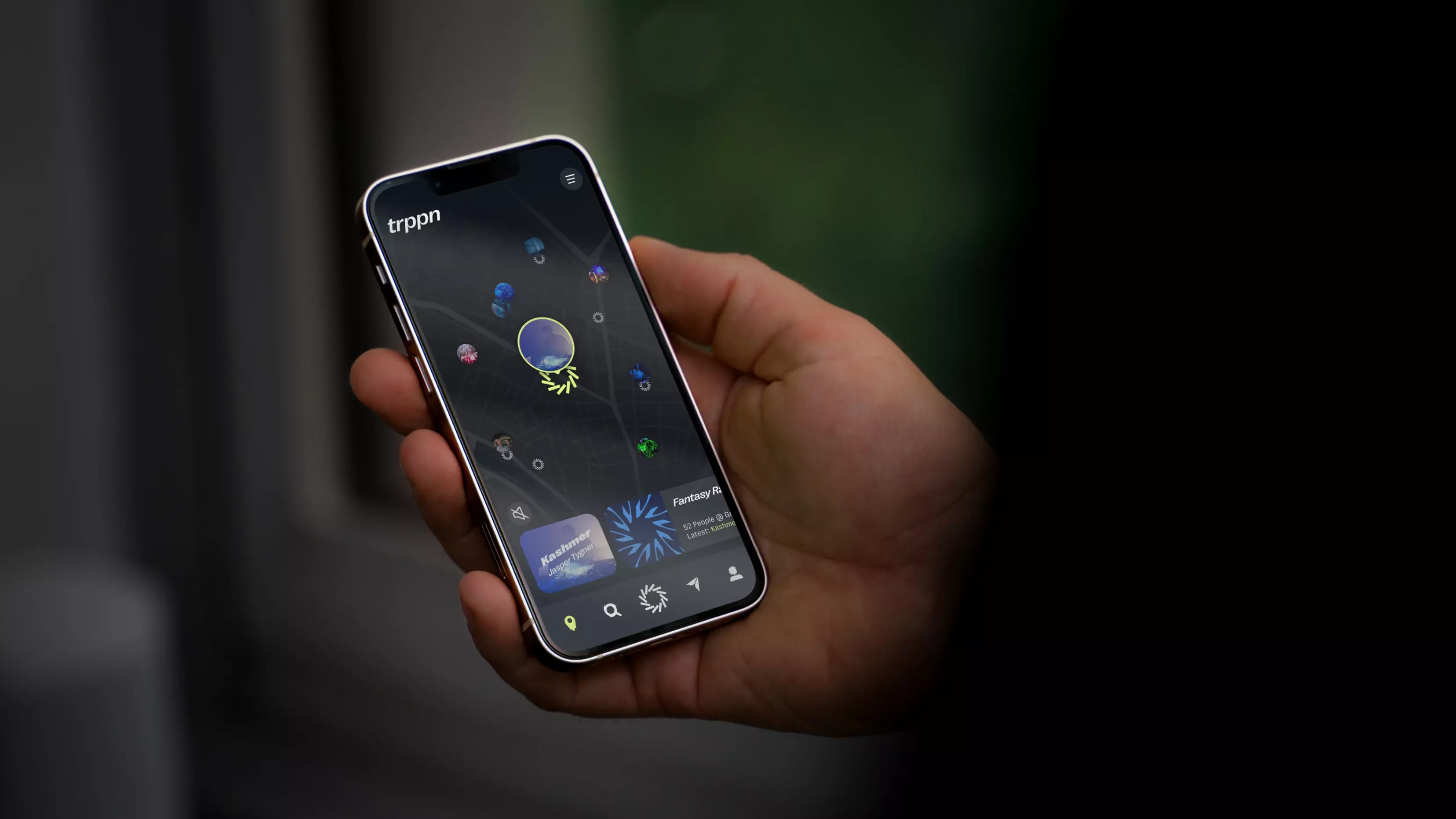 Close-up of a hand holding a smartphone displaying a colorful app interface with abstract graphics and menu icons.