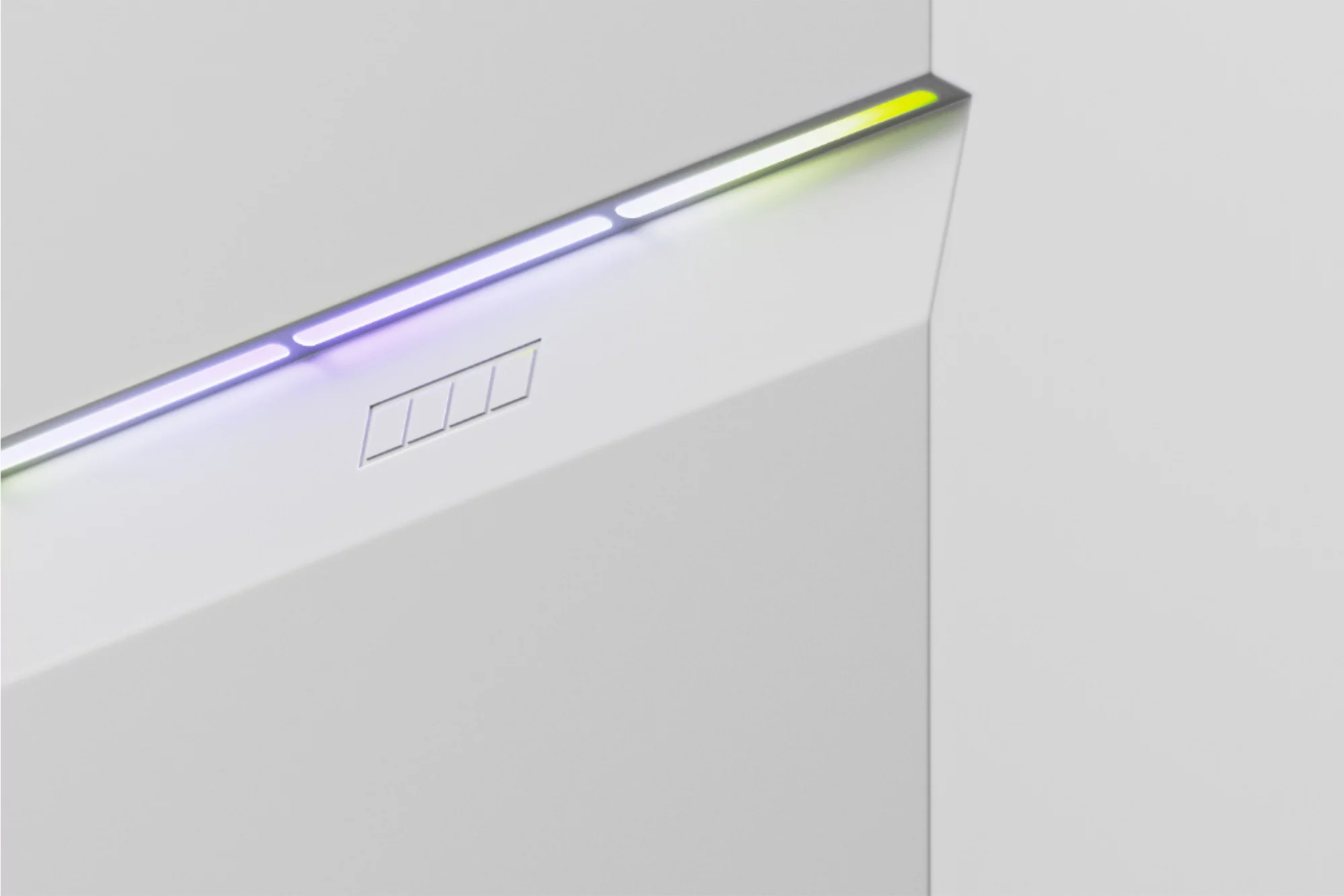 Abstract close-up of a minimalist white structure with linear multicolored LED lighting highlighting its angular geometric forms.