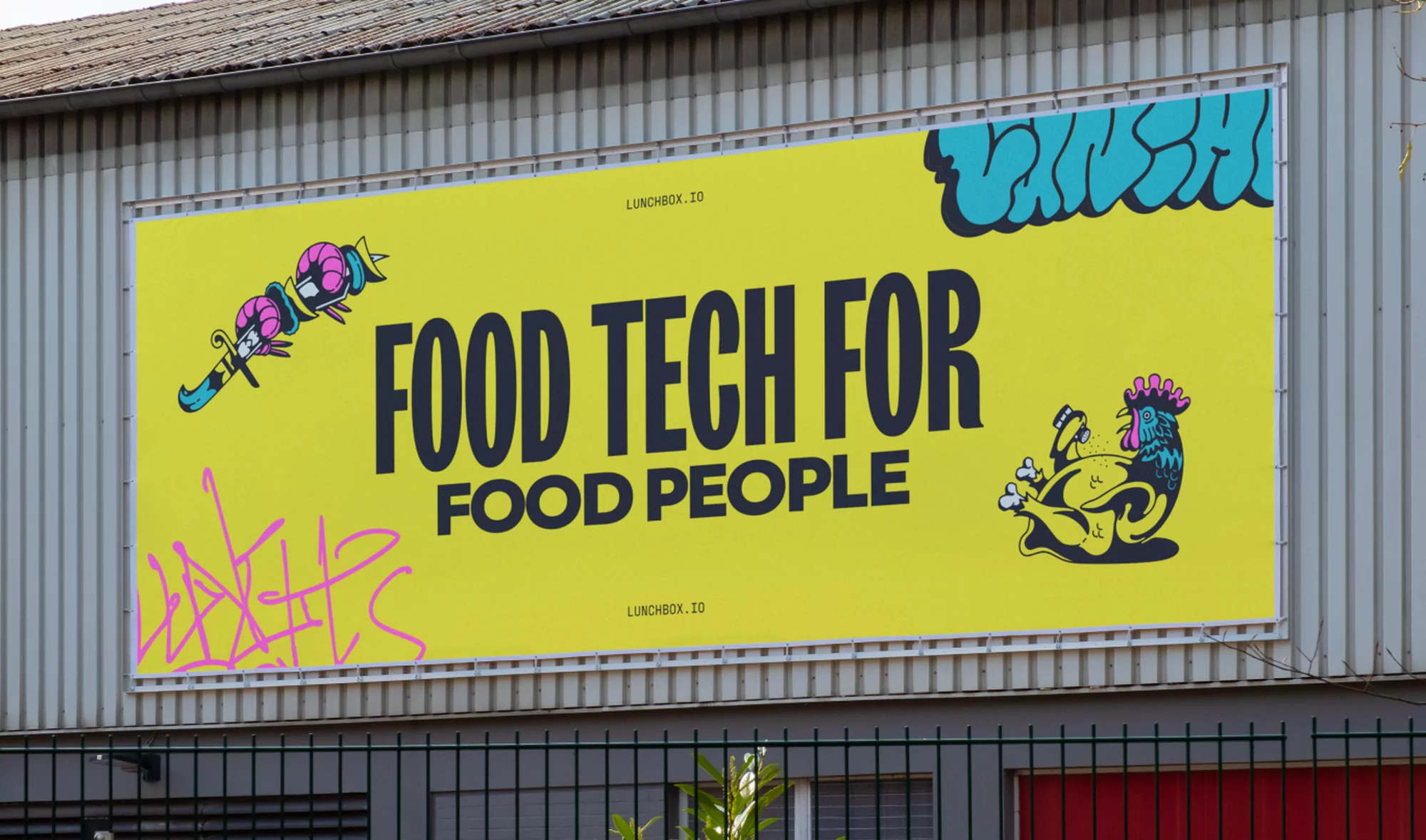 Outdoor billboard advertisement featuring food technology messaging, graffiti-style art, and a cartoon chicken on a bright yellow background.