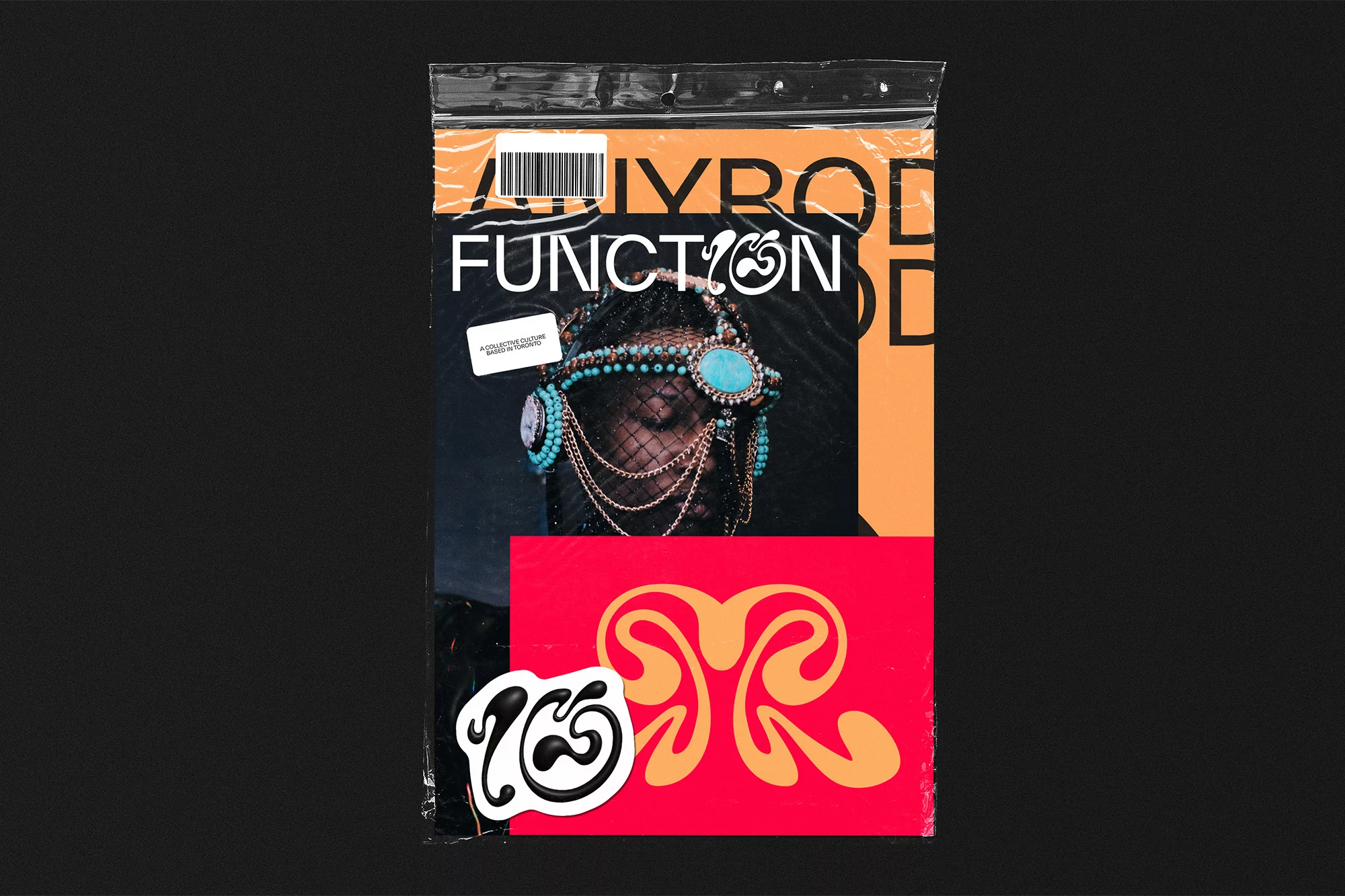 Fashion poster featuring a woman with a jeweled headpiece, set against a bold typographic backdrop in warm tones and packaged in plastic.