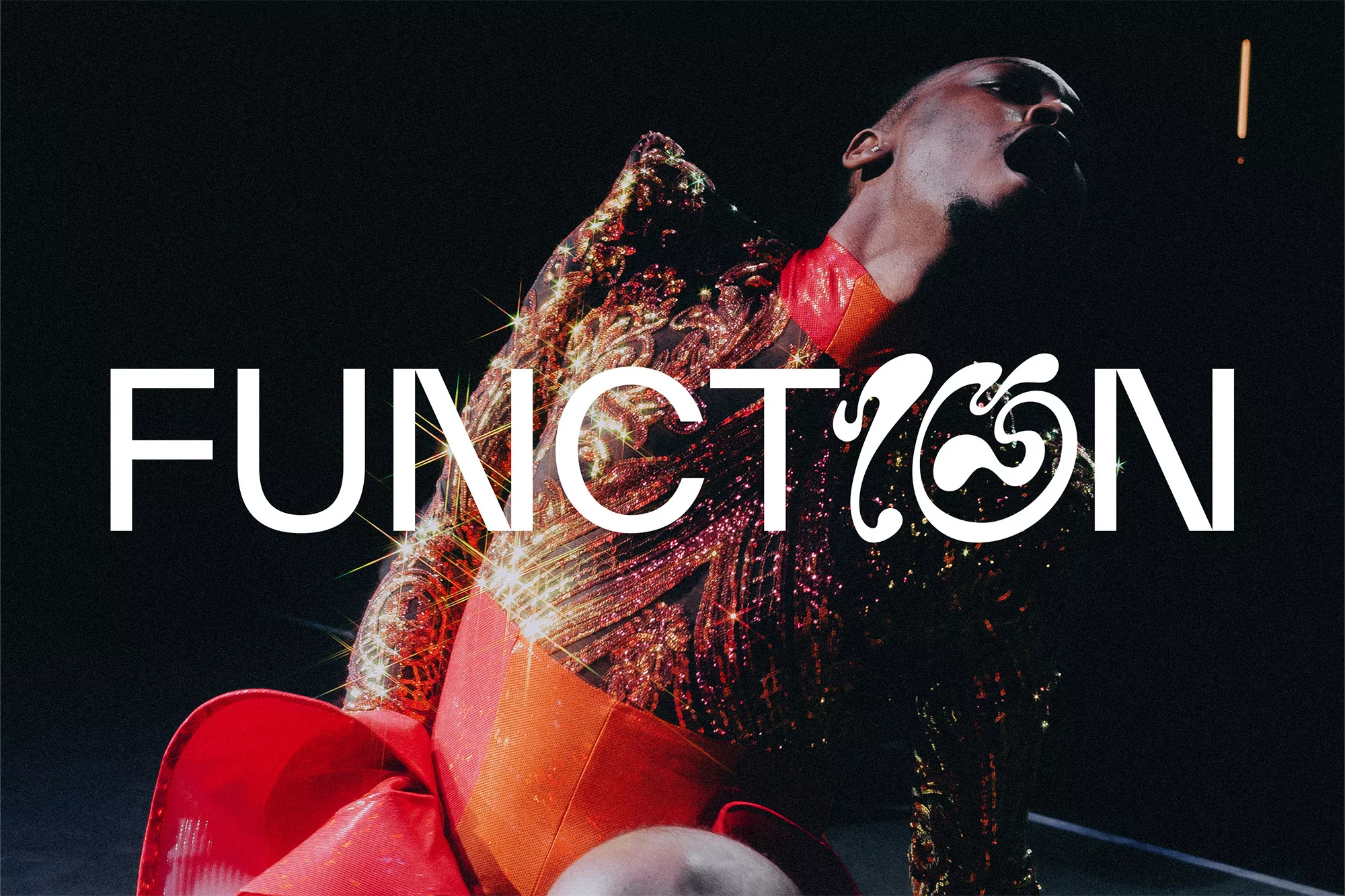 Dancer in a red and gold patterned garment leaning back against a dark background with white typography spelling FUNCTION across the center.