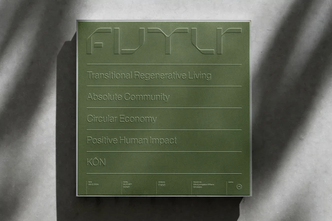 Green sign displaying 'FUTUR' with various sustainable living concepts, set against a neutral background with subtle shadow overlay.