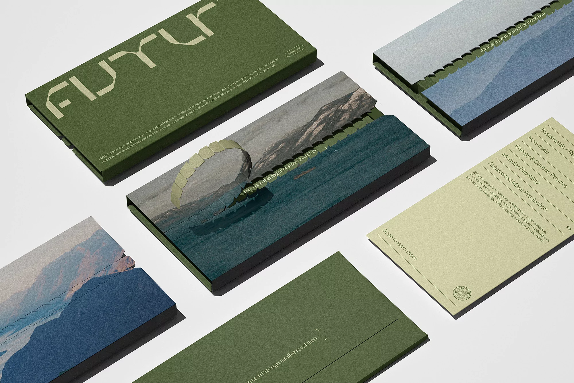Overhead studio shot of futurist product packaging with landscape and earth imagery in shades of green, teal, gray, and beige.
