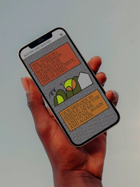 Human hand holds iPhone displaying animated graphic design featuring a website design mockup with earthy color palette and friendly messaging.
