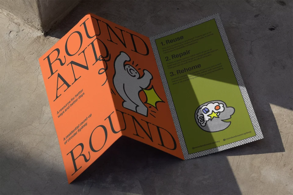 Open brochure featuring cartoon graphics and text on a concrete surface in natural light, showcasing reuse, repair, and rehoming resources.