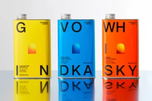 Three colorful tin cans with bold typography spelling gin, vodka, and whisky against a white background.