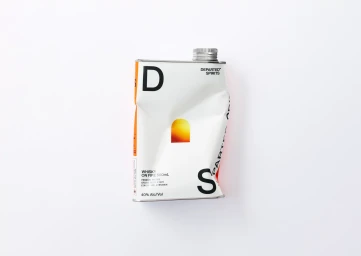 A dented white metal flask with typographic branding resting on a plain white background.