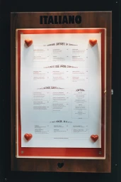 Italiano restaurant menu displayed in a wooden wall-mounted case with red border and four heart magnets.