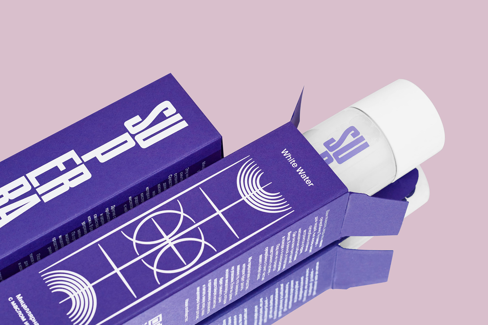 Eye-level shot of a bottle in a purple box with white text and graphic patterns against a light pink background, studio lighting.