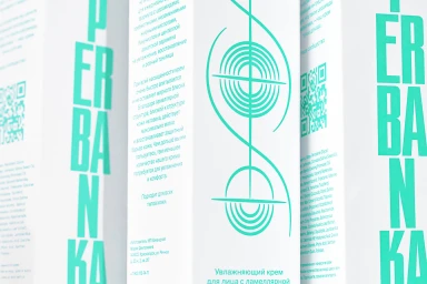 Close-up product packaging for Superbanka featuring white boxes with turquoise branding typography and graphic line art.