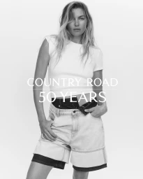 Model wearing a white t-shirt and denim shorts against a white seamless background for Country Road