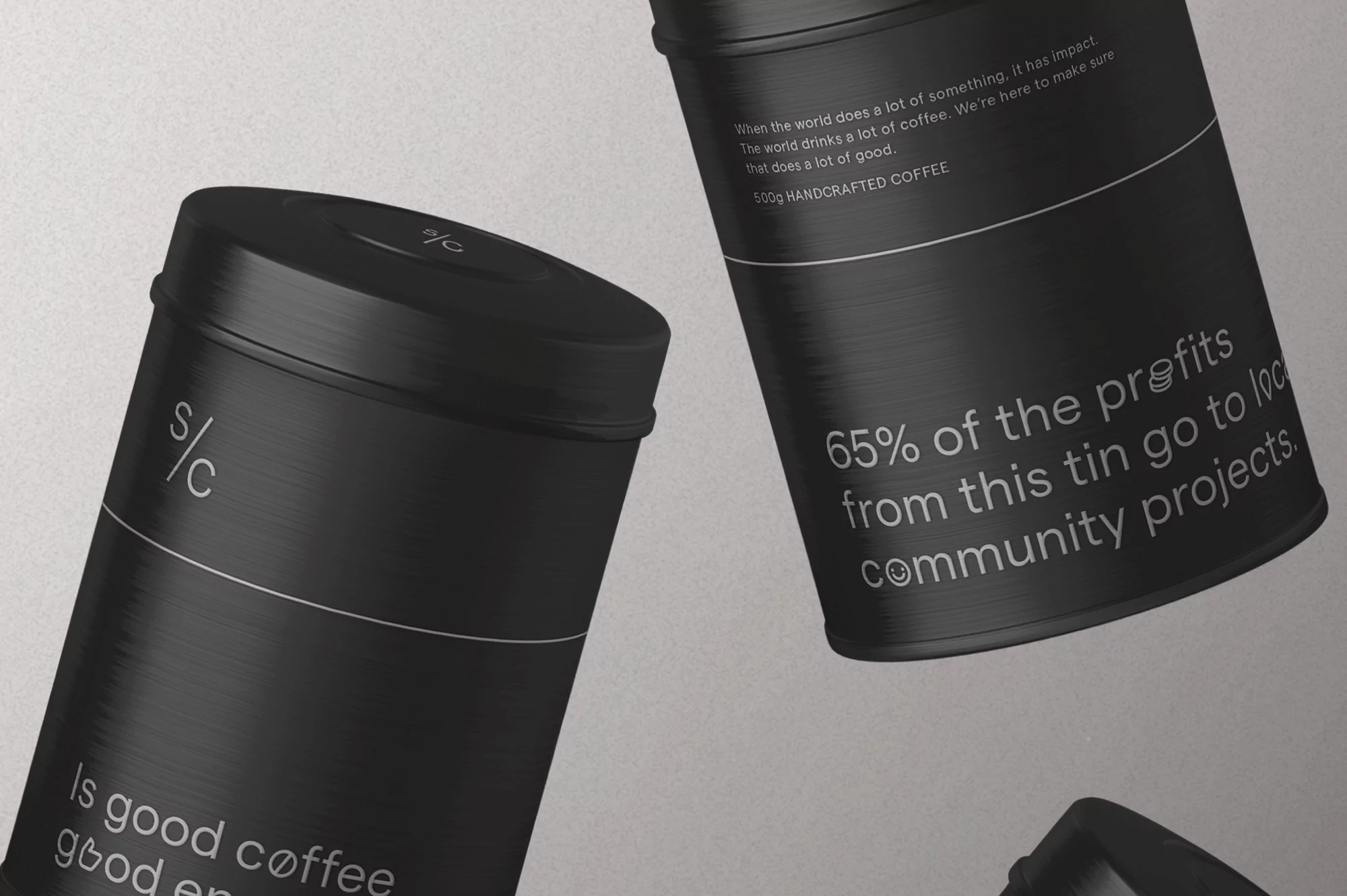 Three black coffee tins are displayed against a pale backdrop, with text in a minimalist design. The tins suggest a handcrafted coffee product.