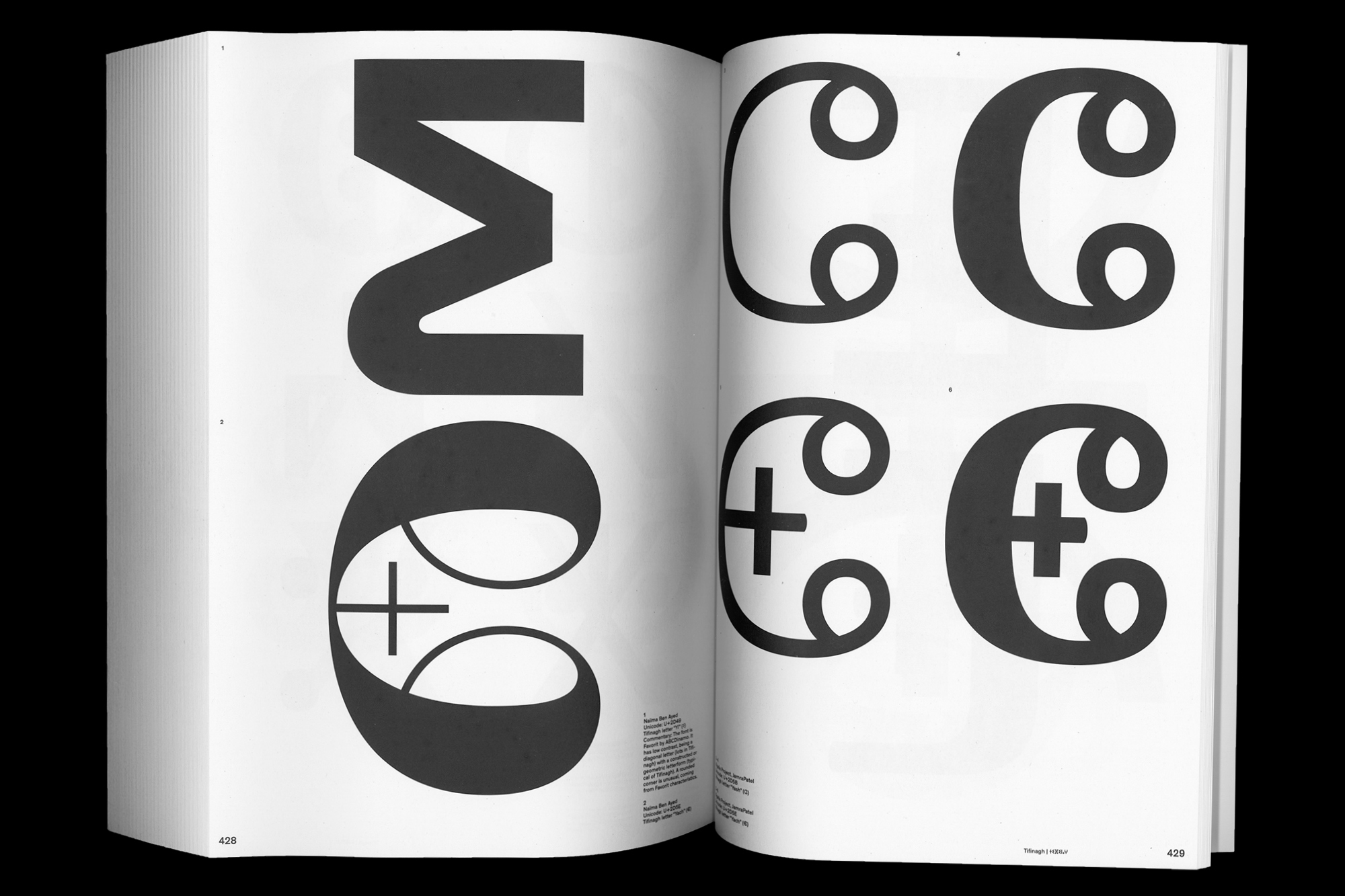 Open book displaying graphic design elements with large, bold typography and geometric shapes in a black and white colour palette.