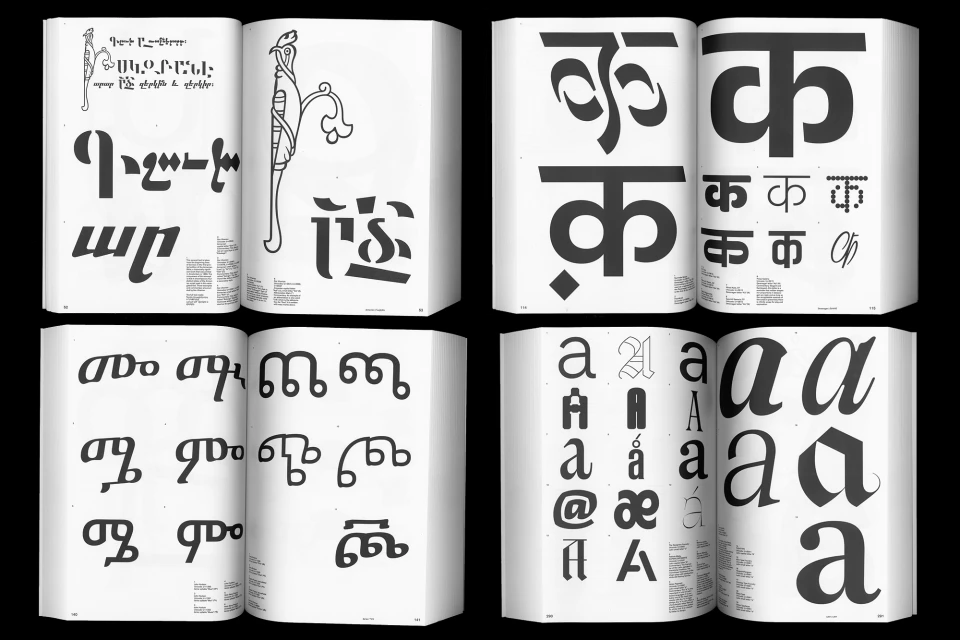 Open books display various alphabets and typographic designs in black ink on white pages, showcased against a stark black background.