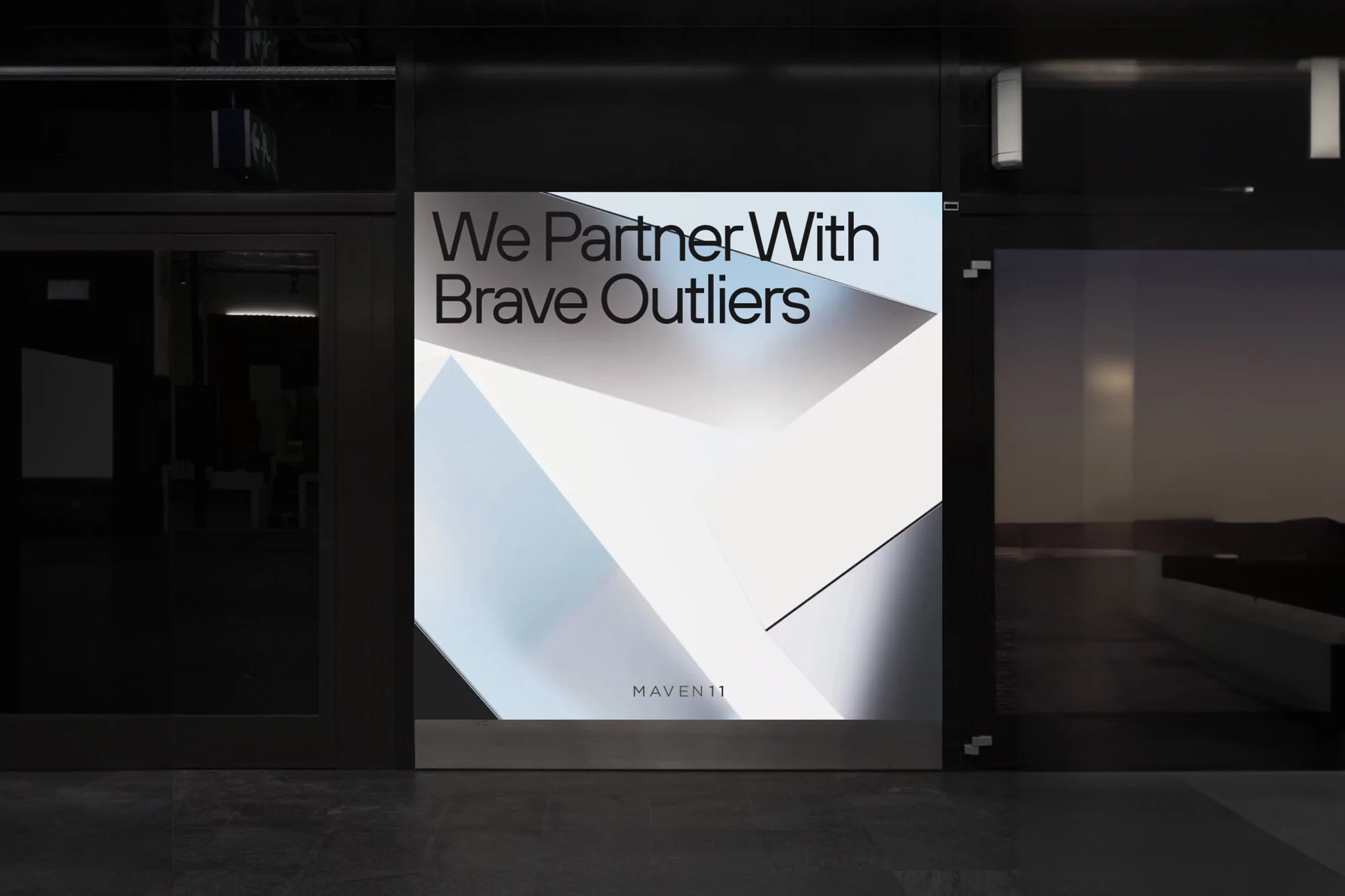 A modern advertising display in an indoor setting showcasing geometric patterns and brand text, set against a neutral architectural backdrop.