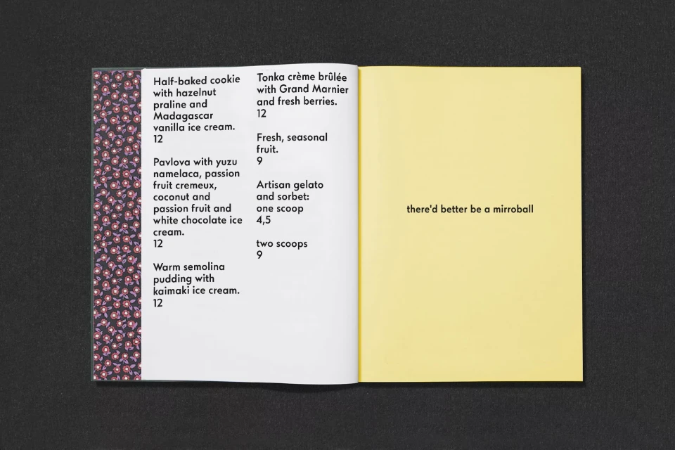Open book with menu on the left page listing desserts and a yellow page on the right with the text, 'there'd better be a mirrorball'.