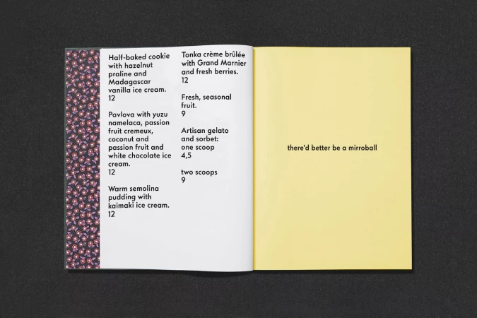 Open book with menu on the left page listing desserts and a yellow page on the right with the text, 'there'd better be a mirrorball'.