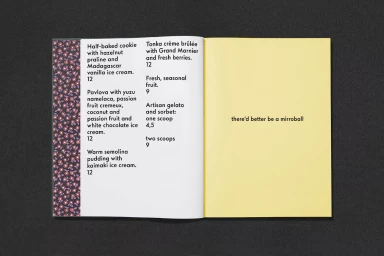 An open menu layout featuring dessert items on the left page and a yellow right page with text set against a dark textured background
