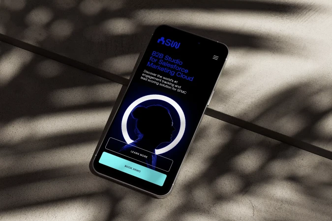 Smartphone displaying B2B Studio for Salesforce Marketing Cloud on a dark surface with shadow patterns creating a contrasting effect.
