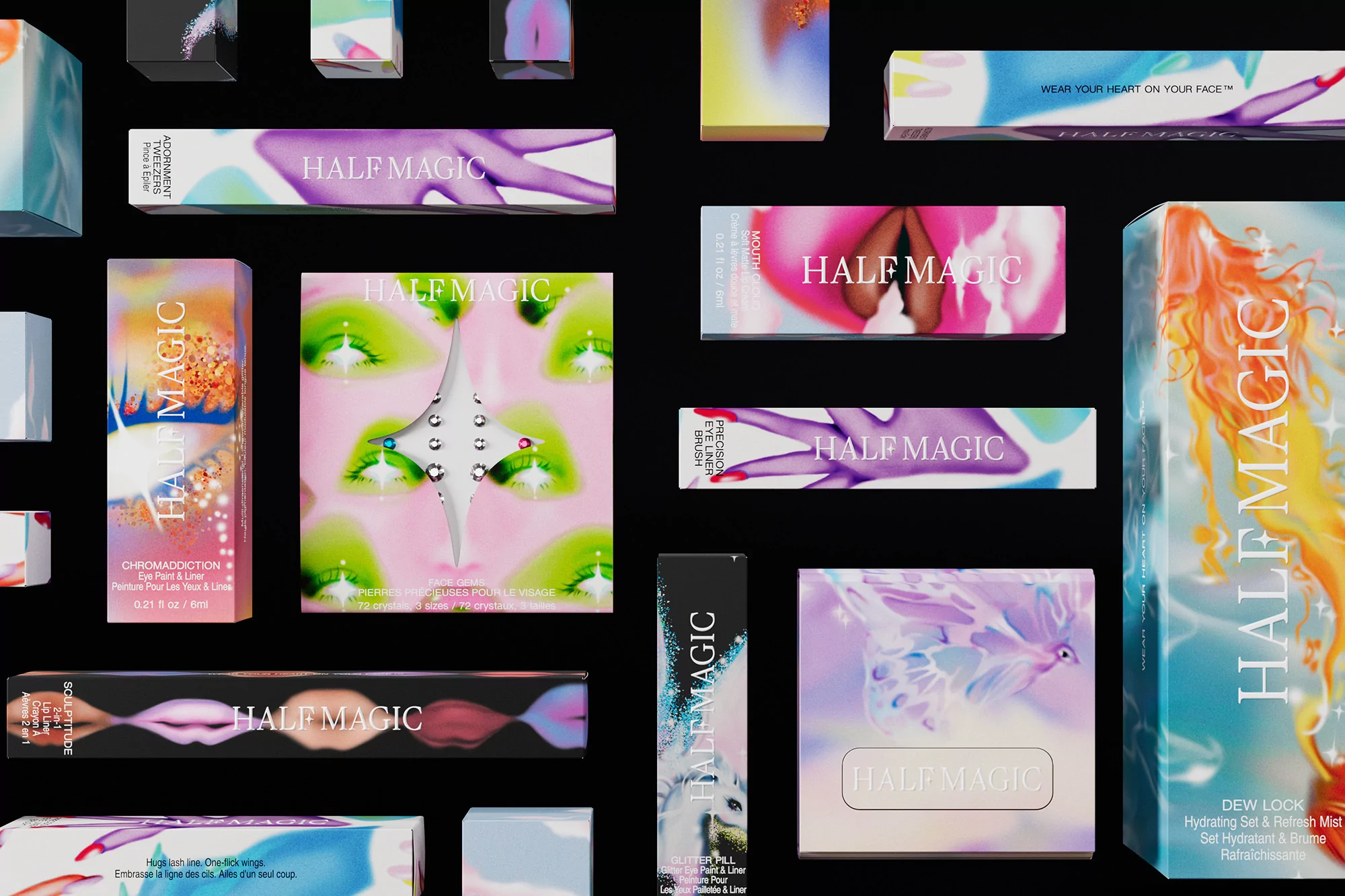 Cosmetic products including eyeshadow palettes, eye liners, and lipsticks from Half Magic against a black background in a studio product shot.