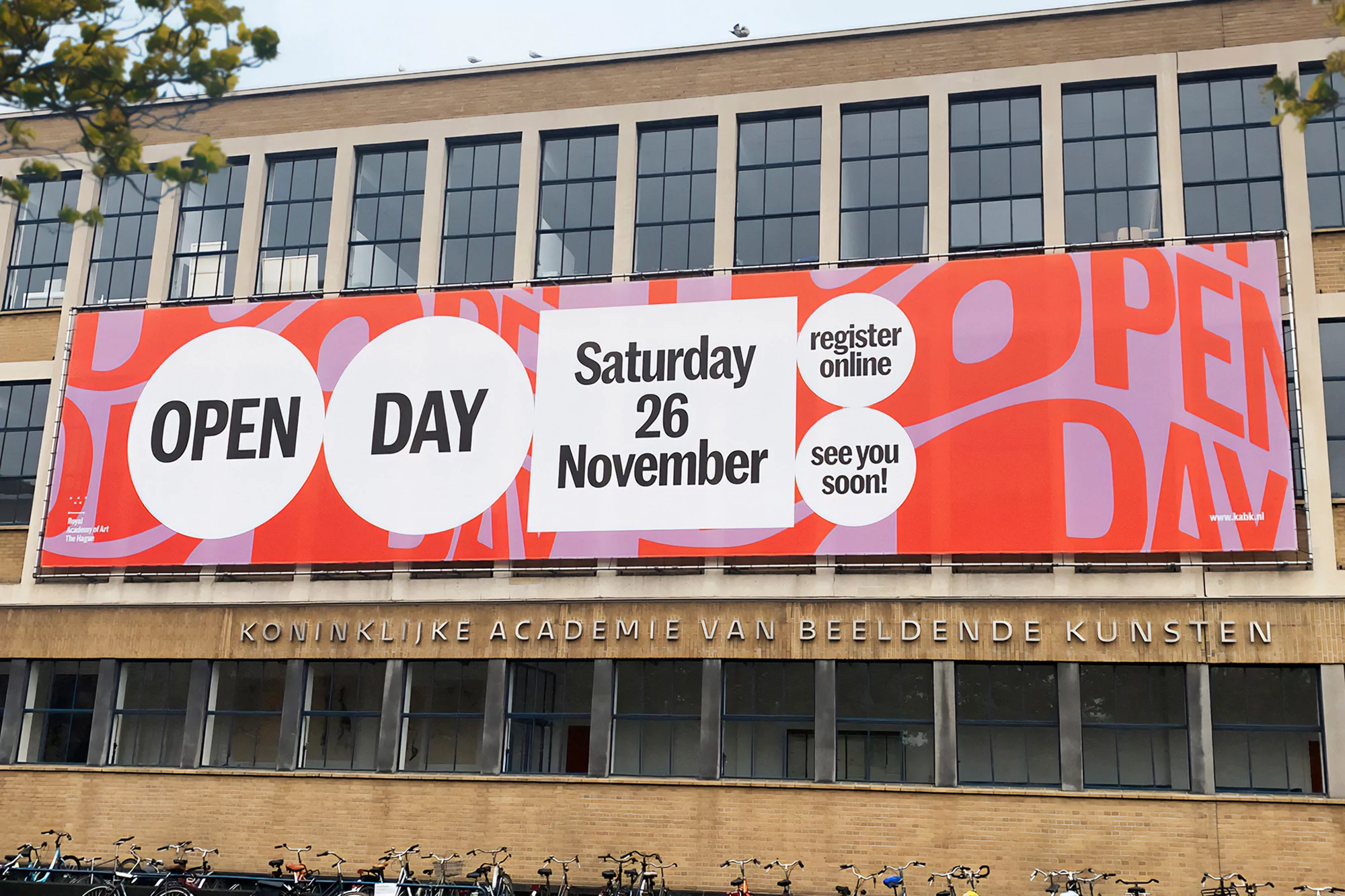 Building with a large banner advertising an open day on Saturday, November 26, for Koninklijke Academie van Beeldende Kunsten.