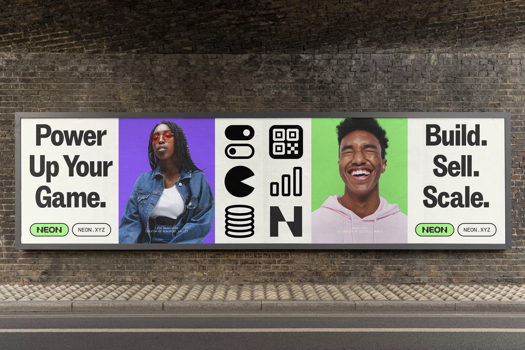 Eye-level shot of outdoor billboard with a young African American woman, smiling man, abstract graphics, and text on a brick wall.
