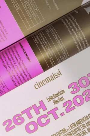 Close-up of printed pages showcasing bold pink and brown typography for Cinemaissi Latin American Film Fest brand identity by Pol Solsona Studio.