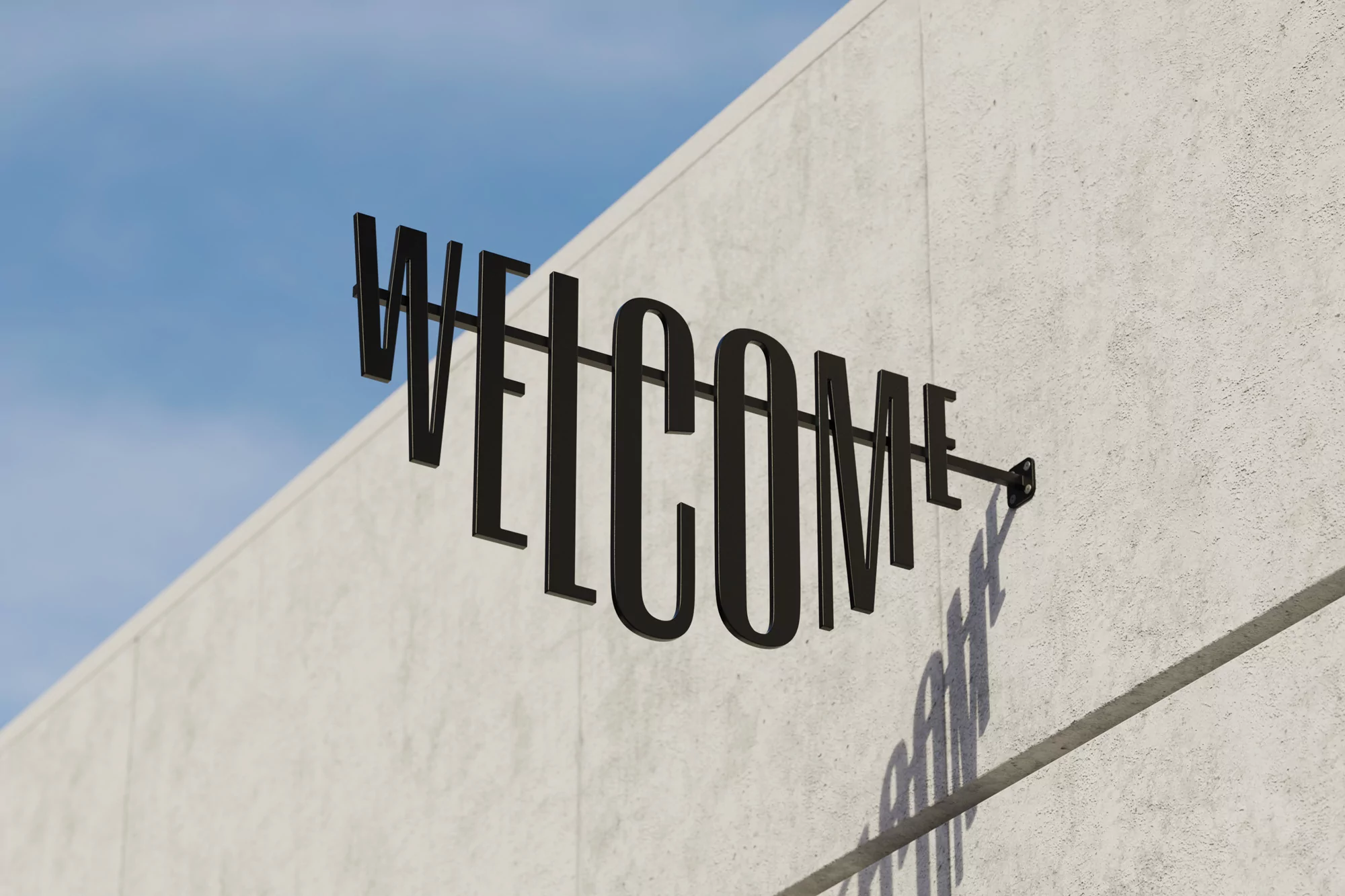 Metal 'Welcome' sign mounted on a concrete wall against a bright blue sky, creating a minimalist and inviting architectural detail.