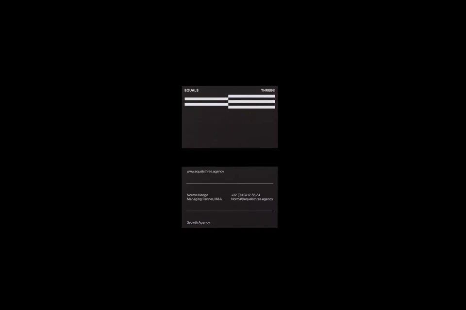 Black and white business cards are stacked, featuring the company name EQUALS THREE, contact information, and growth agency details.