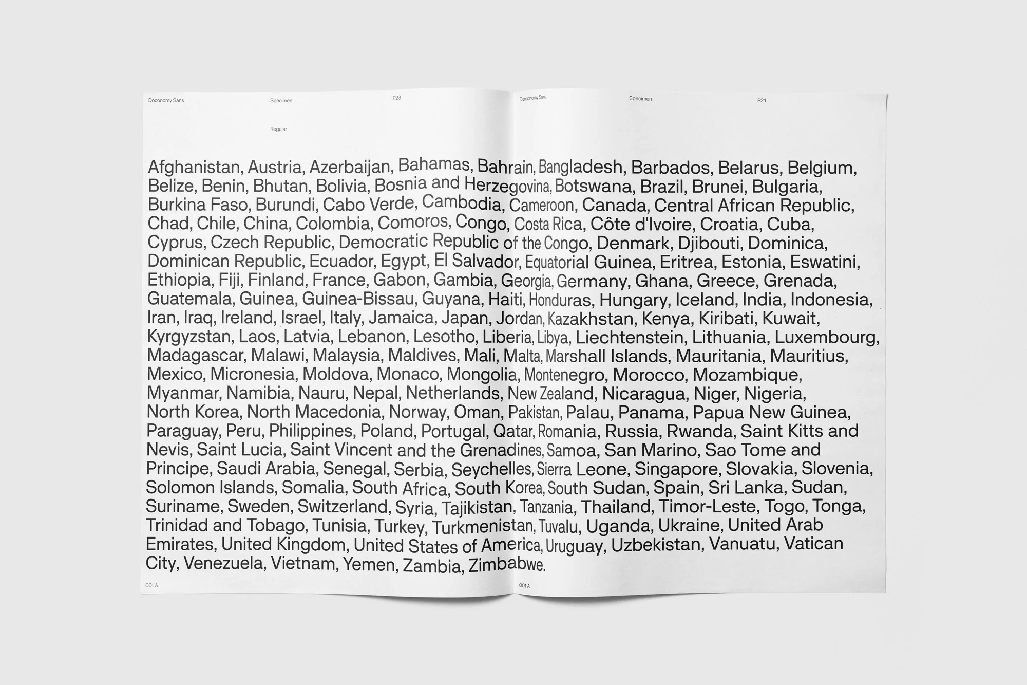 An open spread of a specimen book showing pages filled with aligned lists of country names in clean sans-serif typography.