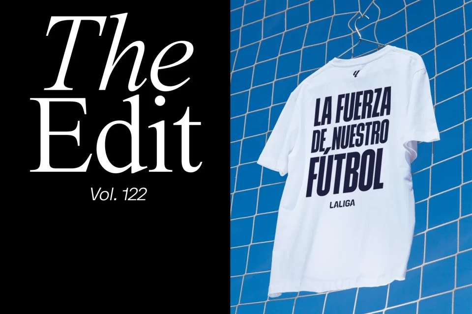 White t-shirt with 'La Liga' branding hangs against a blue net background next to a black panel with white stylized sans-serif text.