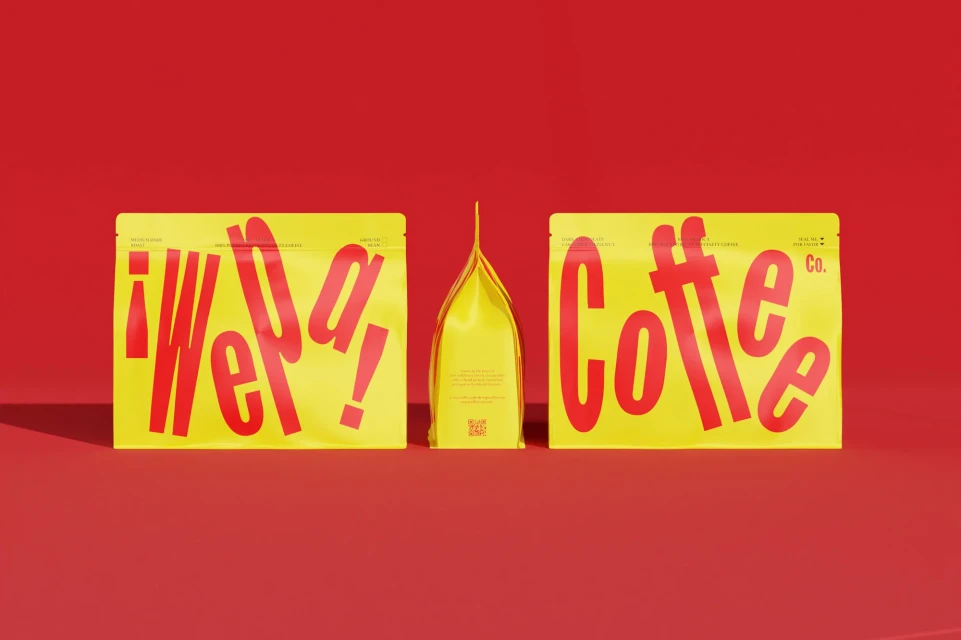 Three yellow coffee bags with red typographic designs. The bags are centered on a red background in a product photography style.