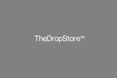 The white text logo of The Drop Store set against a solid neutral grey background.