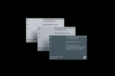 Stacked business cards displaying contact information and typography for YNWA Invest AG on a black background
