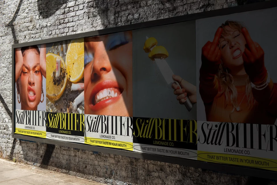 Billboard ad featuring edgy lemonade campaign with close-up portraits, fruit, and provocative gestures on a brick wall backdrop.