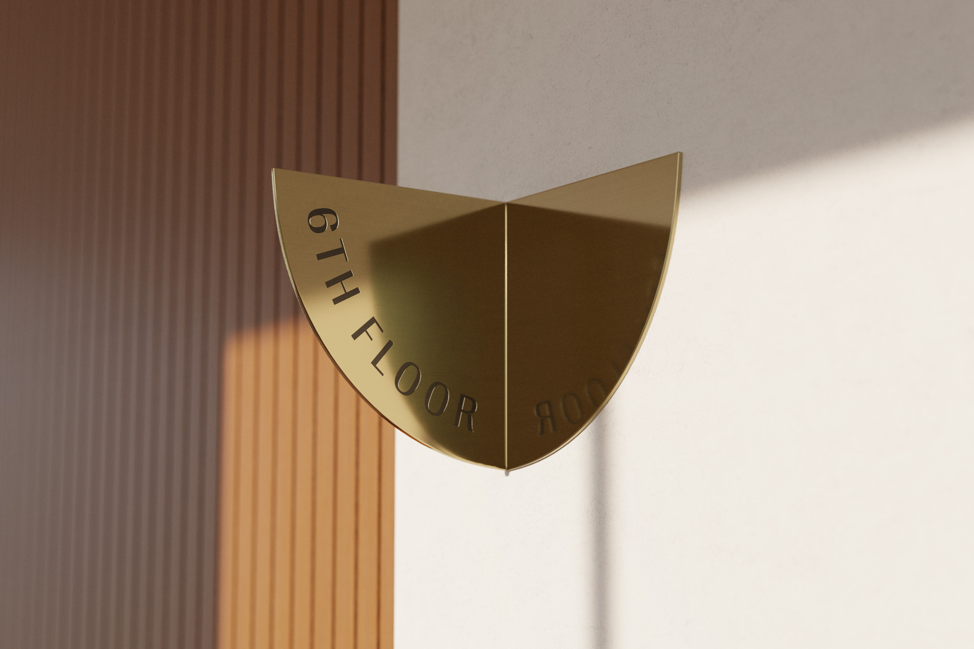 Close-up of a golden sign displaying '6th Floor' in a modern building with minimalist design and warm, inviting lighting.