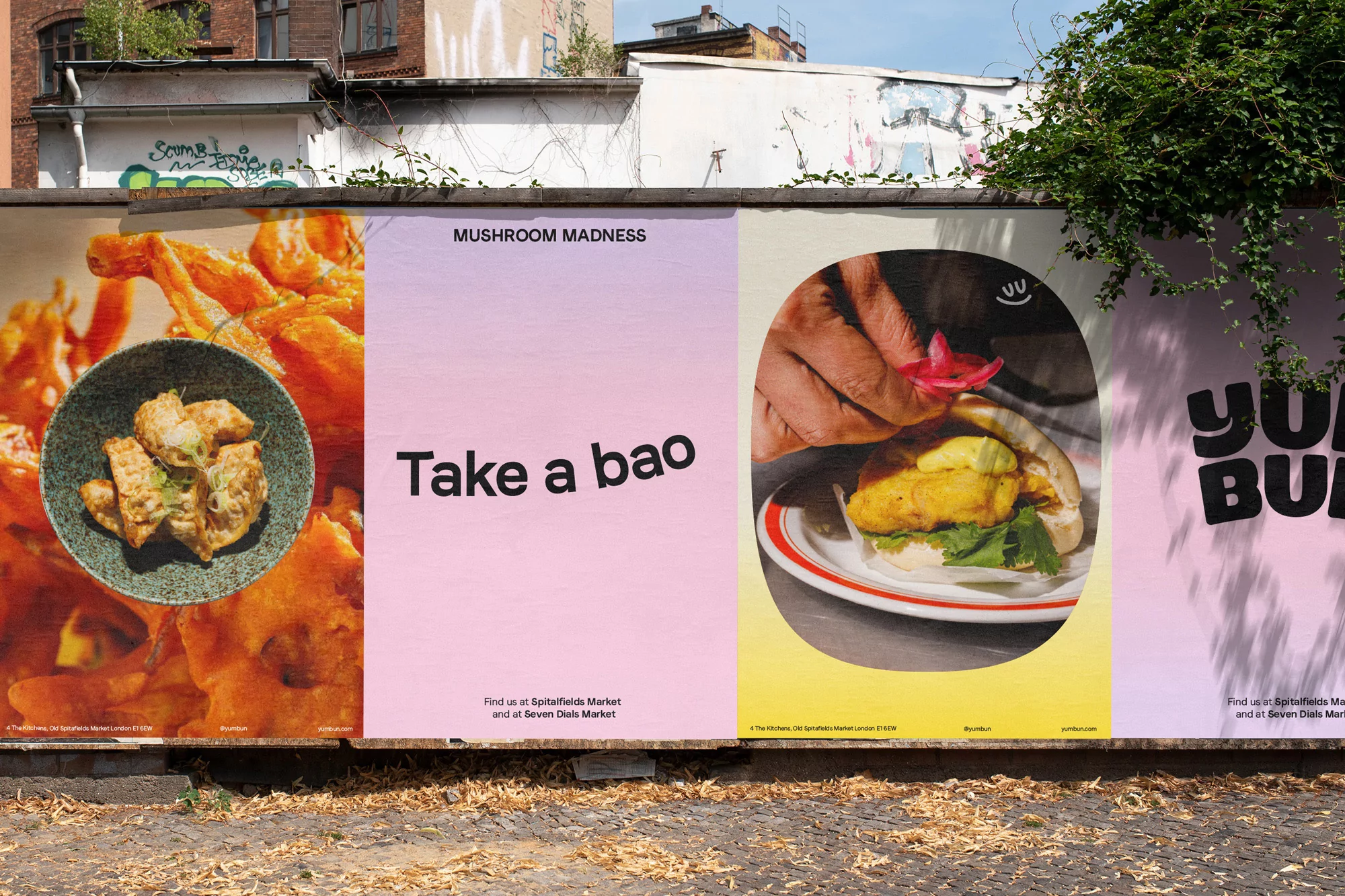 Outdoor posters display food photography: fried dishes, text "Mushroom Madness Take a Bao", and brand promotion on a city street.