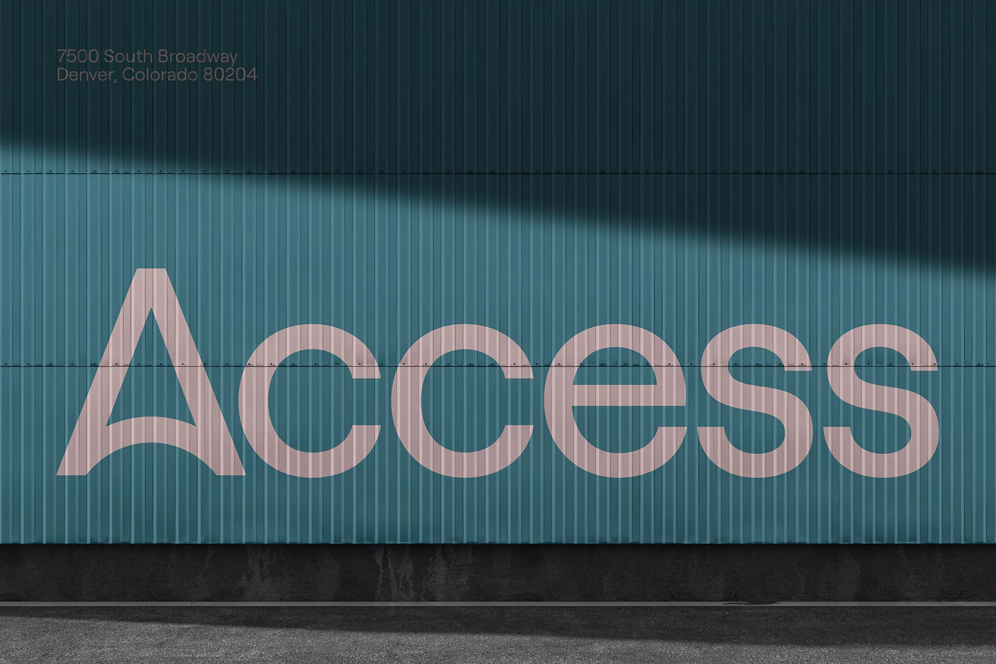 Exterior shot of a teal corrugated metal building with the word ACCESS in light pink lettering. The building address is visible above.