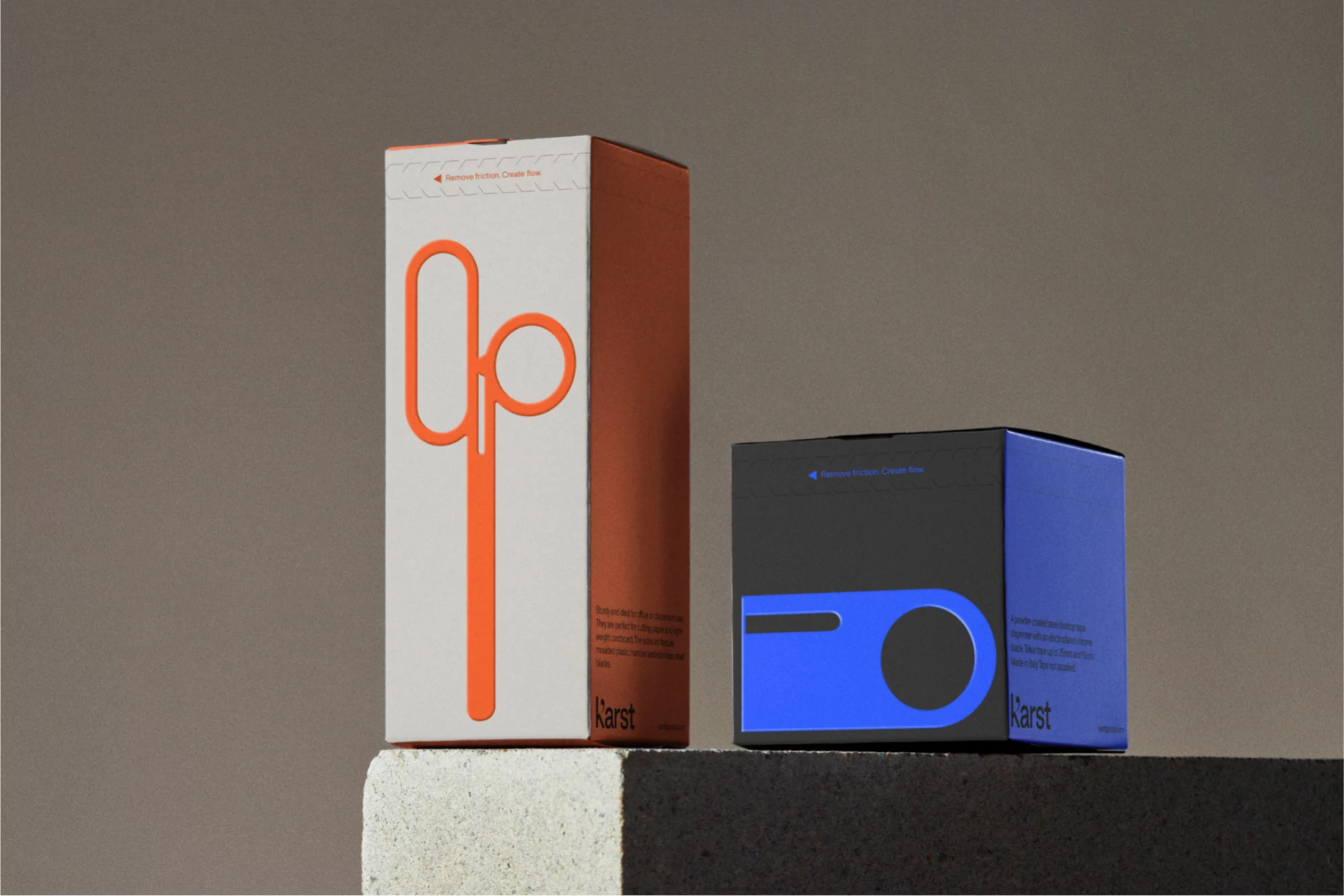 Two Karst stationery product boxes on a neutral surface show minimalist design, an orange paper up tool, and a blue planner box.