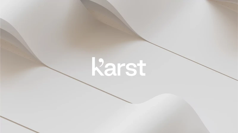 Abstract shot of curving white panels with the Karst logo, creating a minimalist, elegant visual.