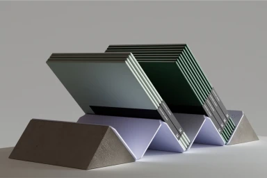 Two stacks of notebooks resting at an angle in a light purple pleated stand against a grey studio background