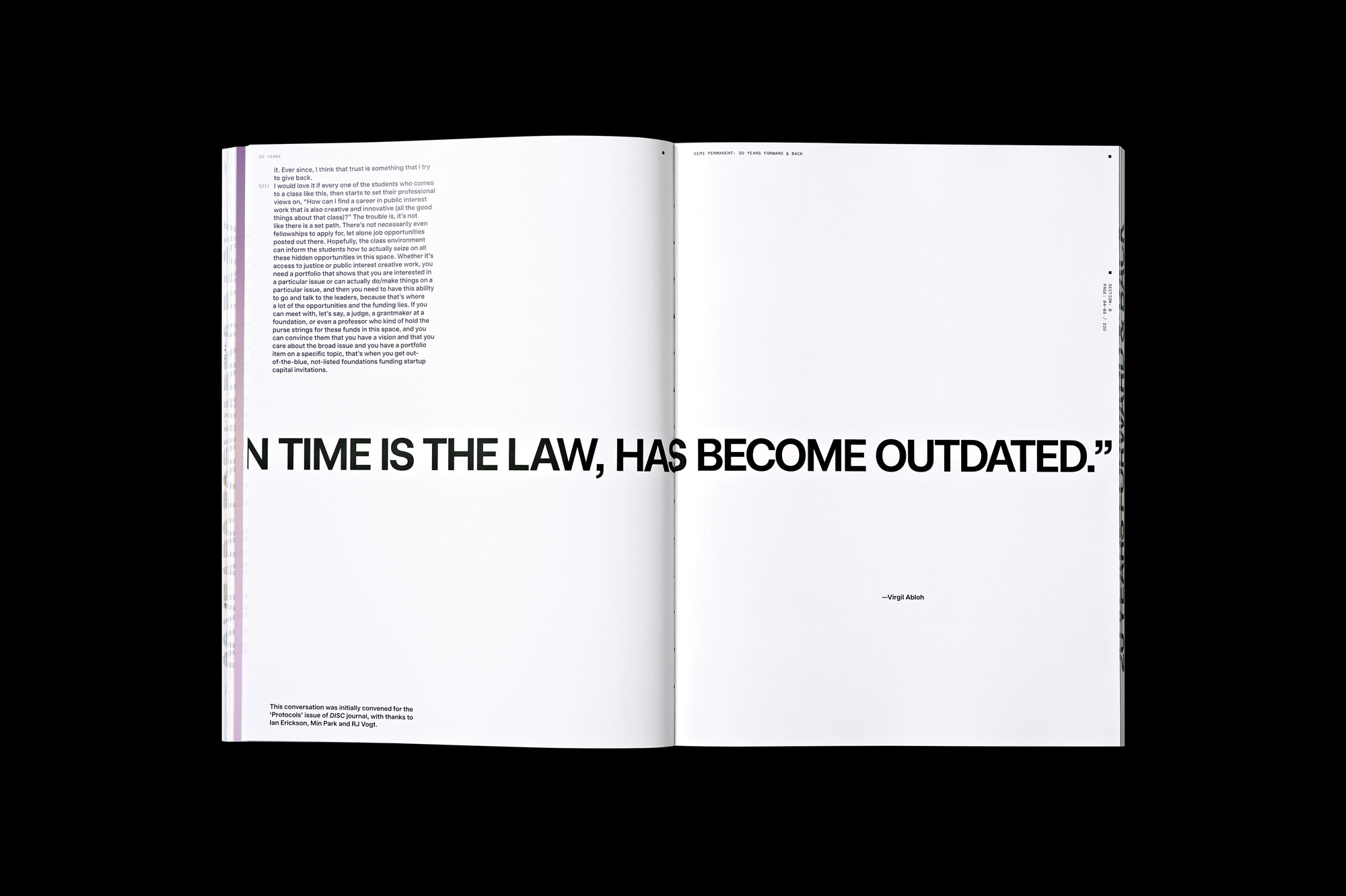 Open magazine spread features bold black typography on white pages, design layout, reading material, and modern graphic design elements.