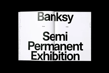 An open magazine layout featuring bold black typography with the words Banksy and Semi Permanent Exhibition on a white background