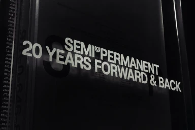 Close-up typography reading SEMI PERMANENT 20 YEARS FORWARD AND BACK in bold white sans-serif letters against a dark surface.